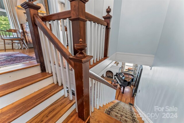 staircase with hardwood / wood-style flooring