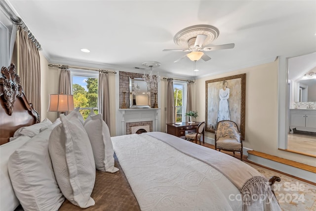 bedroom with crown molding, ceiling fan, and ensuite bathroom