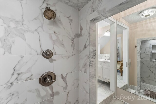 404 Avery Ave, Morganton, NC 28655 - bathroom featuring a tile shower, marble look tiles, and a sink