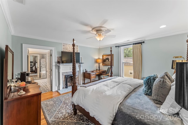 bedroom featuring connected bathroom, crown molding, light hardwood / wood-style floors, and ceiling fan