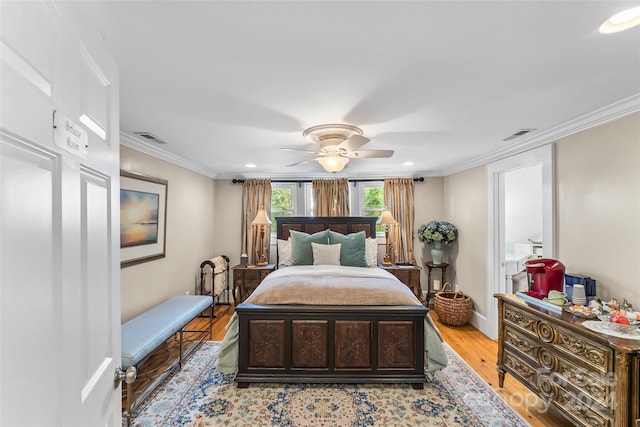 bedroom featuring light hardwood / wood-style floors, ceiling fan, and crown molding