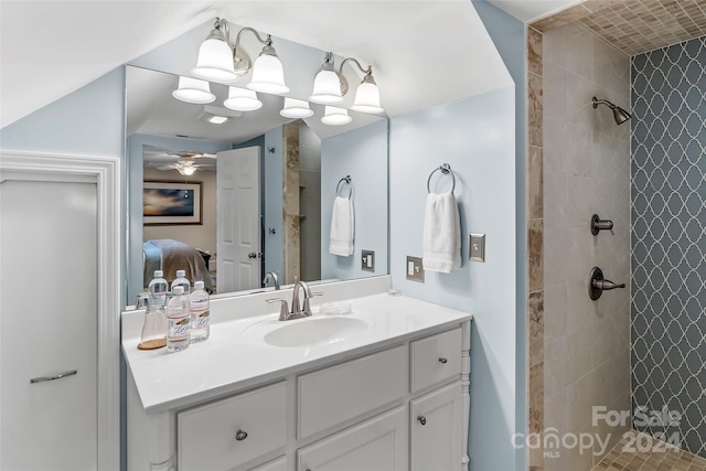 bathroom with ceiling fan, vanity, and a tile shower