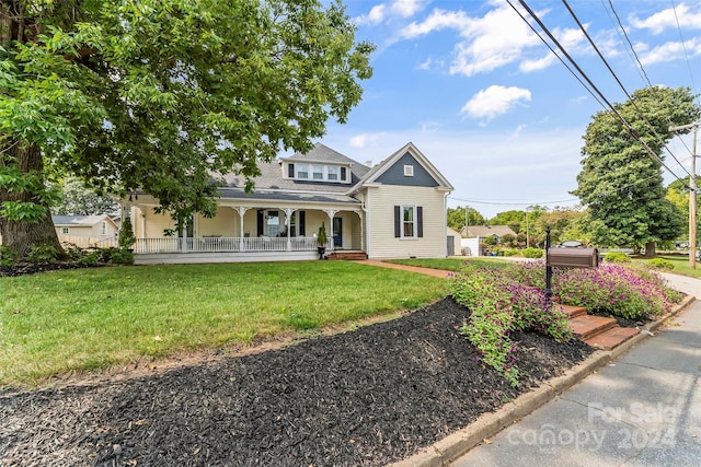 view of front facade with a front yard and a porch