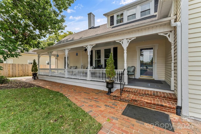 view of exterior entry with covered porch