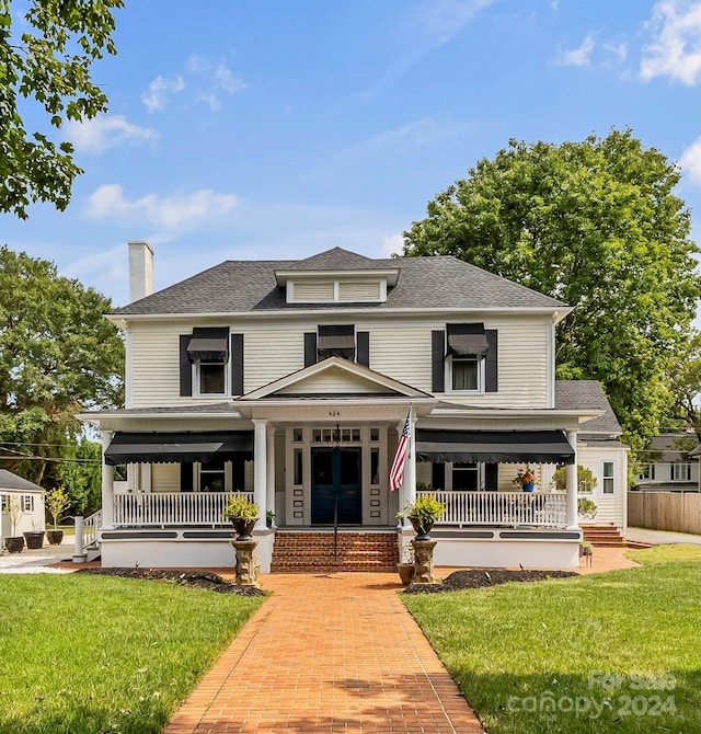 view of front of house with a front yard and a porch