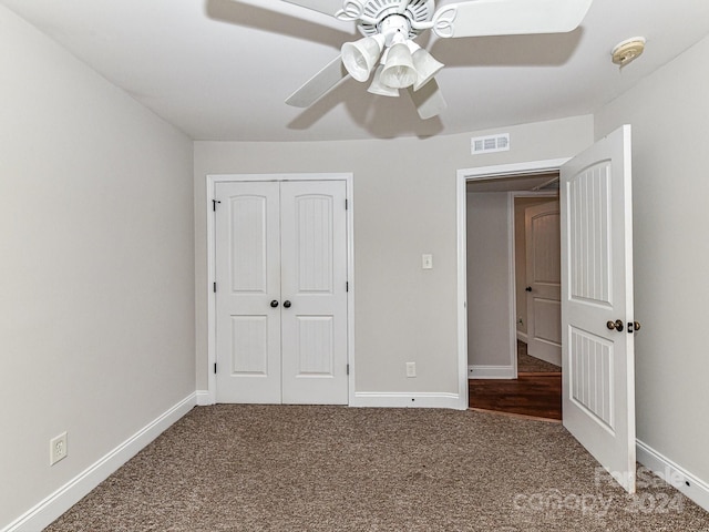 unfurnished bedroom with ceiling fan, carpet floors, and a closet