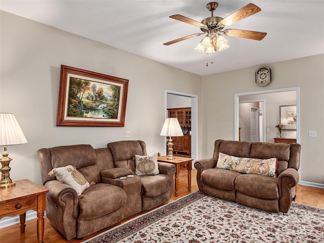 living room with ceiling fan and wood-type flooring