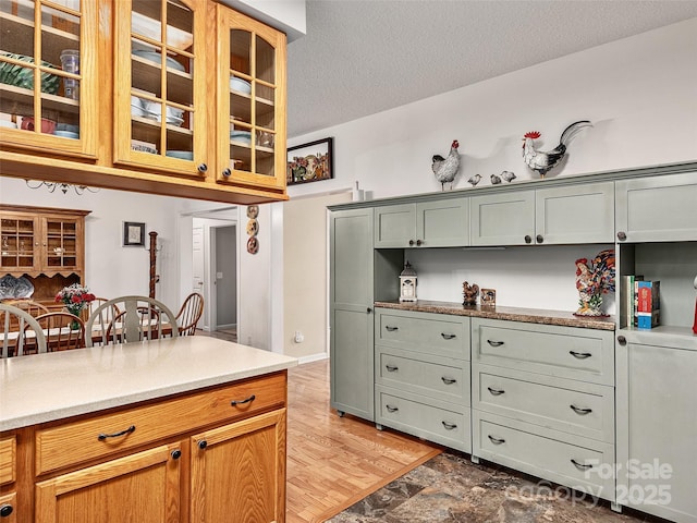 kitchen with hardwood / wood-style floors and a textured ceiling