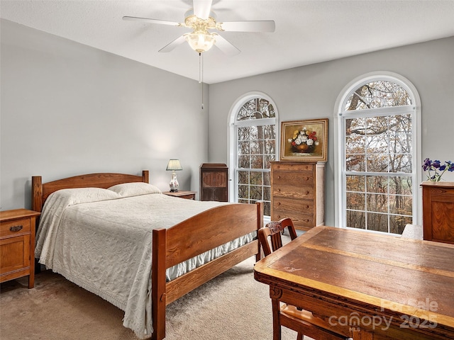 bedroom featuring ceiling fan and light colored carpet