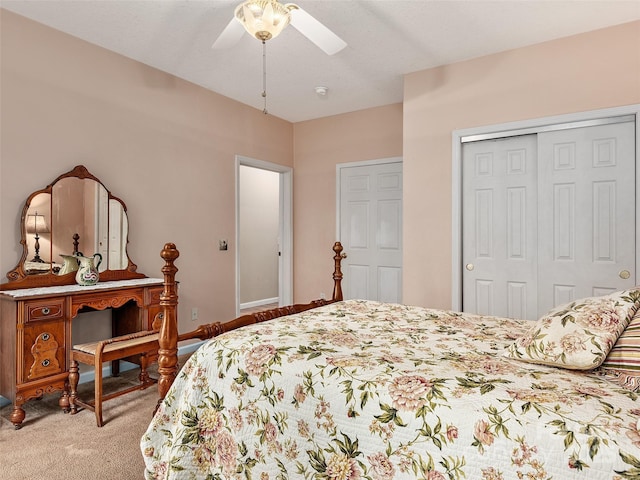 bedroom featuring a closet, light colored carpet, and ceiling fan