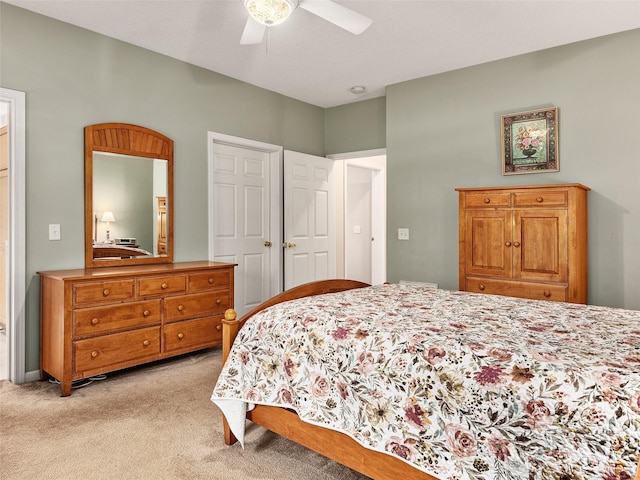 bedroom featuring ceiling fan and light carpet