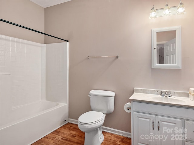 full bathroom with hardwood / wood-style flooring, toilet, vanity, and tub / shower combination