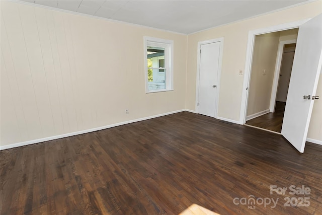 unfurnished bedroom featuring dark hardwood / wood-style flooring and crown molding