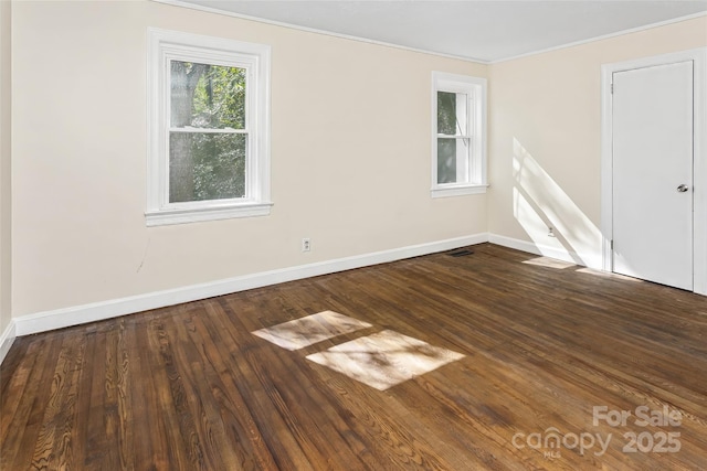 unfurnished room featuring wood-type flooring and crown molding