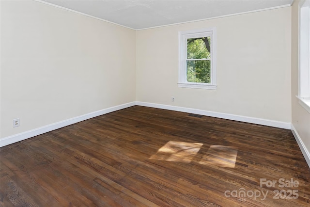 unfurnished room with dark wood-type flooring and ornamental molding