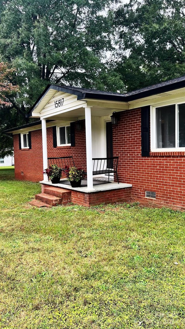 view of front of home with a front yard and a porch