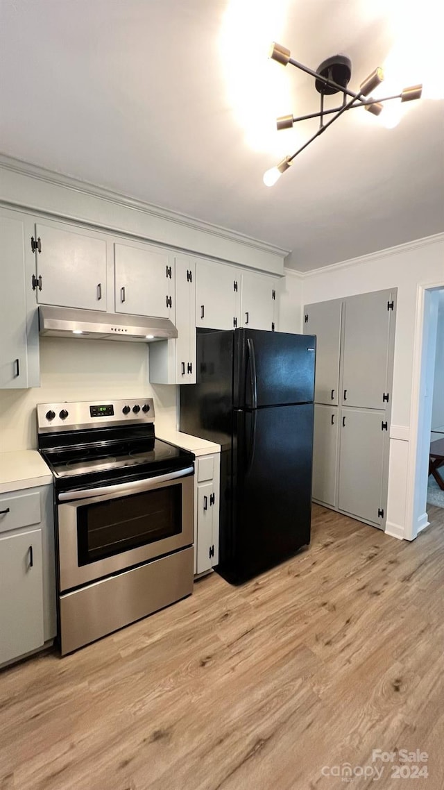 kitchen with white cabinets, electric stove, light hardwood / wood-style flooring, ornamental molding, and black refrigerator