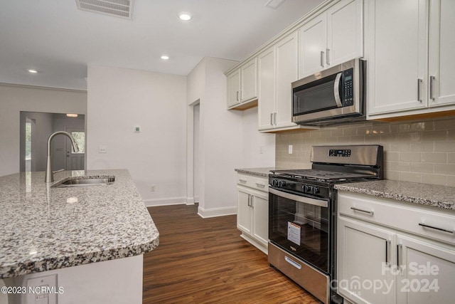 kitchen with sink, stainless steel appliances, dark hardwood / wood-style flooring, and white cabinetry