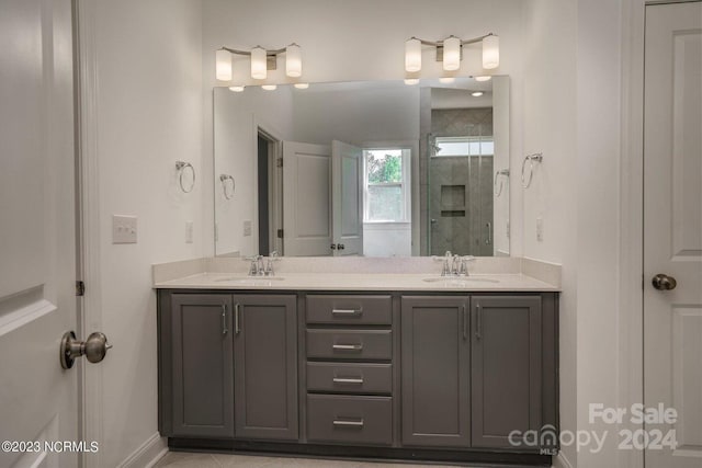 bathroom featuring vanity, a shower with door, and tile patterned floors