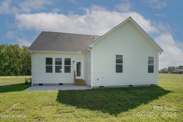 rear view of property with a yard