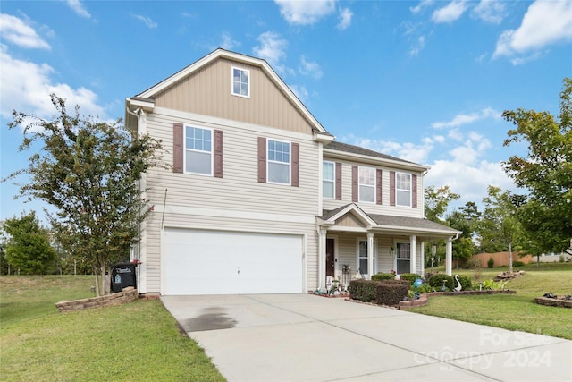 view of front of home with a garage, a front lawn, and covered porch