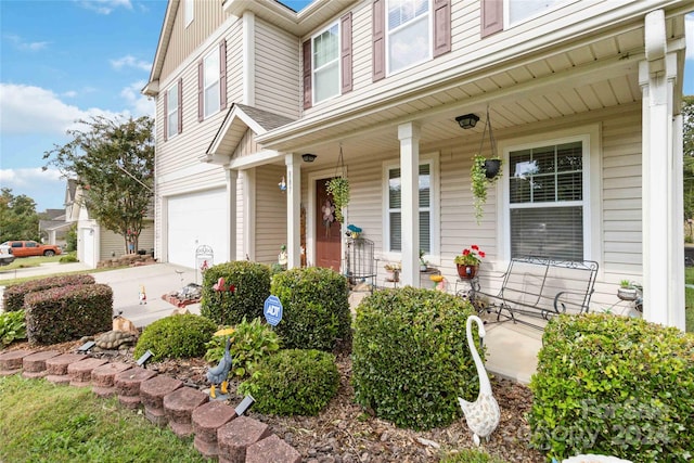 entrance to property with a garage and covered porch