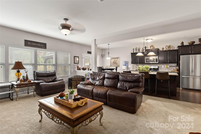 living room with ceiling fan and light carpet