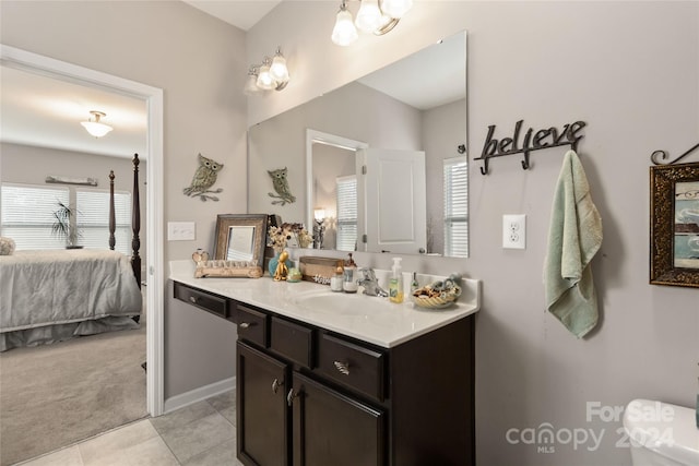 bathroom with vanity, toilet, tile patterned floors, and plenty of natural light