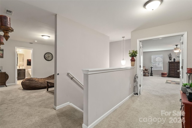 hallway featuring light carpet