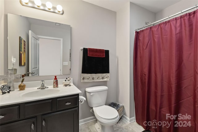 bathroom featuring tile patterned floors, walk in shower, vanity, and toilet