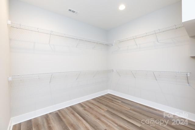 walk in closet featuring hardwood / wood-style flooring