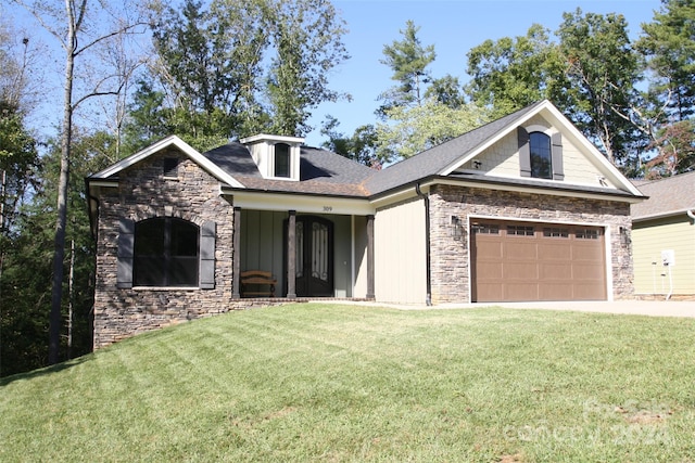 view of front facade with a front yard and a garage