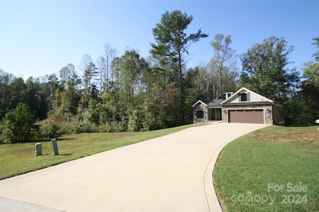 view of front of house with a garage and a front lawn