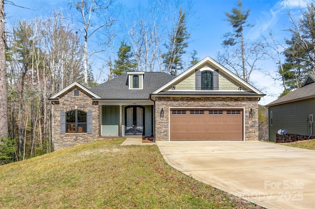 craftsman inspired home featuring roof with shingles, a garage, stone siding, driveway, and a front lawn