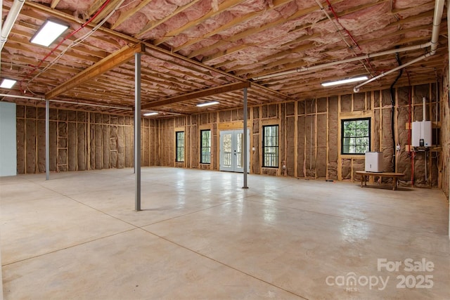 misc room featuring concrete flooring and tankless water heater