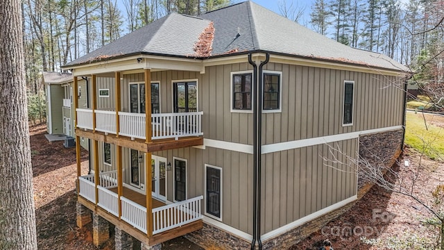 view of side of home featuring roof with shingles and board and batten siding