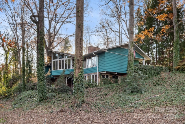 back of house featuring a sunroom