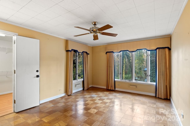 spare room featuring a wealth of natural light, ceiling fan, and ornamental molding