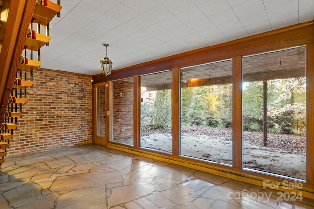 interior space with plenty of natural light and brick wall