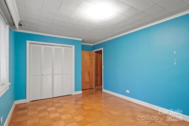 unfurnished bedroom with a closet, light parquet floors, and ornamental molding