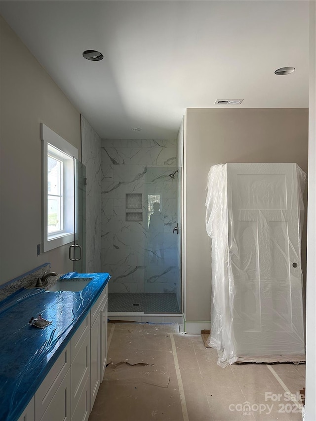 bathroom featuring vanity and an enclosed shower