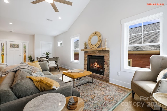 living area with high vaulted ceiling, recessed lighting, a fireplace, visible vents, and baseboards