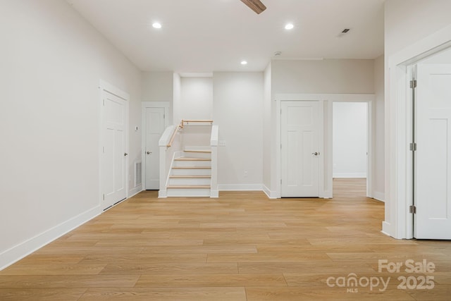 spare room featuring recessed lighting, visible vents, baseboards, stairway, and light wood finished floors