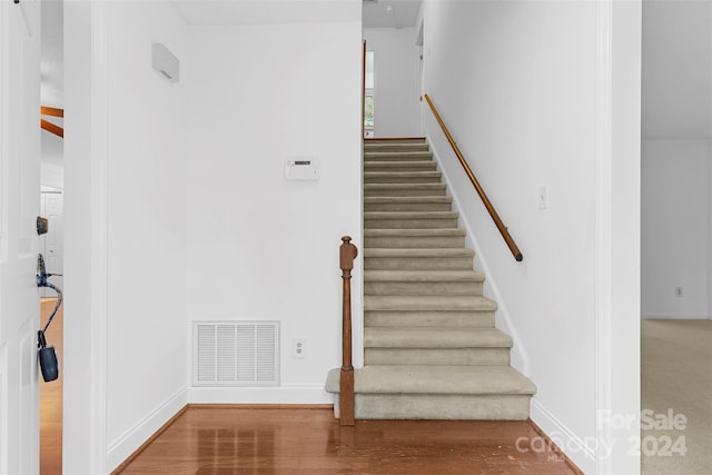 staircase featuring hardwood / wood-style flooring