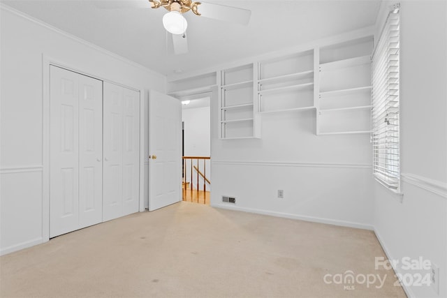 interior space featuring ceiling fan and light colored carpet