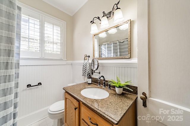 bathroom featuring radiator, tile patterned flooring, toilet, vanity, and ornamental molding