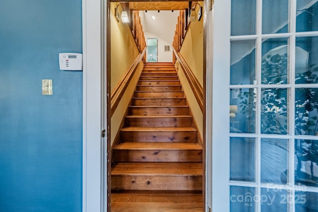 stairs featuring wood-type flooring