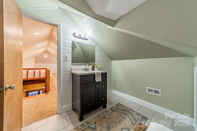 bathroom featuring vanity and vaulted ceiling