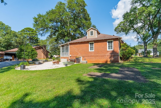 rear view of property with a yard and cooling unit