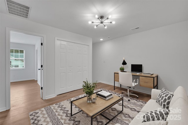 living room with hardwood / wood-style floors and a chandelier